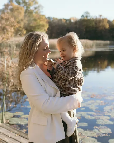 Ashlei laughing with her family on a dock by the lake